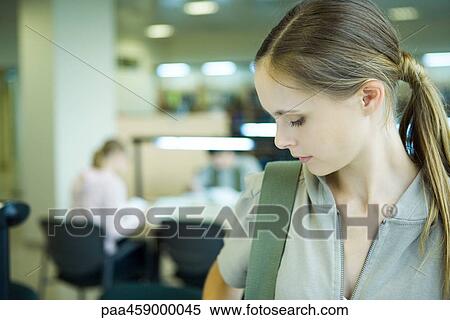 Female student looking down, head and shoulders View Large Photo Image Stock Photography - Female student looking down, head and shoulders. Fotosearch