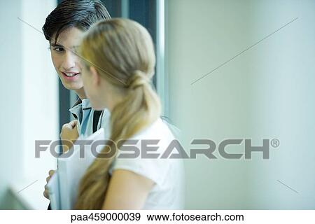 Two students chatting together, side view View Large Photo Image Stock Photo - Two students chatting together, side view. Fotosearch