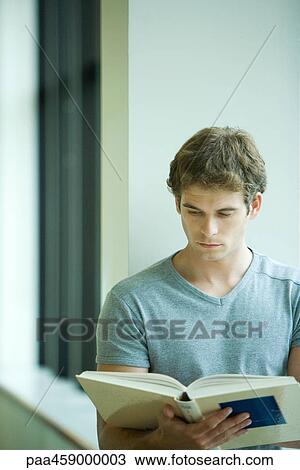 Young man reading book, close-up View Large Photo Image Stock Image - Young man reading book, close-up. Fotosearch