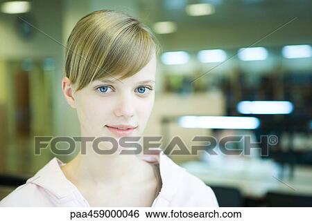 Young woman smiling at camera, head and shoulders, portrait View Large Photo Image Stock Photograph - Young woman smiling at camera, head and shoulders, portrait. Fotosearch