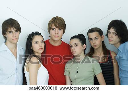 Group of young friends posing for photo, looking at camera, portrait View Large Photo Image Stock Photo - Group of young friends posing for photo, looking at camera, portrait. Fotosearch