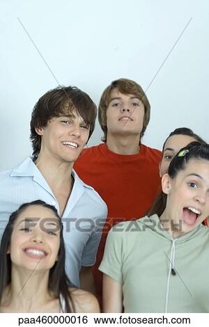 Group of young friends posing for photo, smiling at camera, portrait View Large Photo Image Stock Photograph - Group of young friends posing for photo, smiling at camera, portrait. Fotosearch