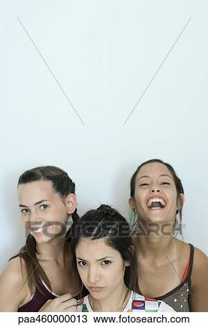 Three young female friends smiling at camera, head and shoulders, portrait View Large Photo Image Stock Image - Three young female friends smiling at camera, head and shoulders, portrait. Fotosearch