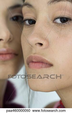 Two young female friends, looking at camera, cropped View Large Photo Image Stock Image - Two young female friends, looking at camera, cropped. Fotosearch