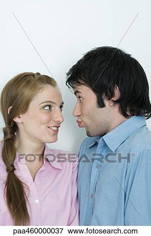 Young couple making goofy faces at each other, head and shoulders, portrait View Large Photo Image Stock Photo - Young couple making goofy faces at each other, head and shoulders, portrait. Fotosearch