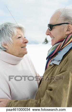 Picture - Senior couple smiling at each other, side view, portrait. Fotosearch