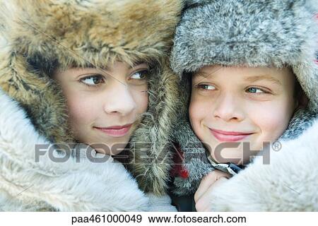 Sister and brother wearing fur caps, smiling, looking away, portrait View Large Photo Image Stock Photo - Sister and brother wearing fur caps, smiling, looking away, portrait. Fotosearch