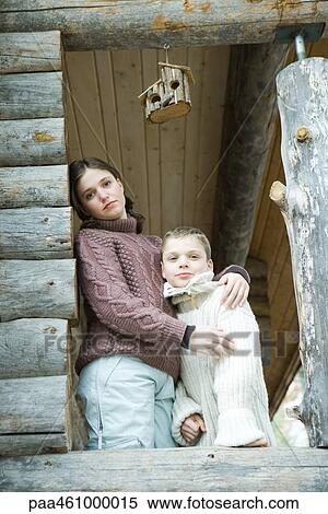 Teen girl embracing little brother, both smiling at camera, portrait View Large Photo Image Stock Photography - Teen girl embracing little brother, both smiling at camera, portrait. Fotosearch