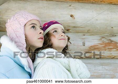 Two young friends looking up, portrait View Large Photo Image Stock Image - Two young friends looking up, portrait. Fotosearch