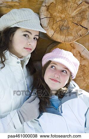 Two young friends smiling, wearing caps. one looking at camera, portrait View Large Photo Image Stock Photo - Two young friends smiling, wearing caps. one looking at camera, portrait. Fotosearch