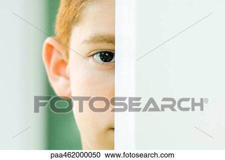 Boy peeking at camera, cropped portrait View Large Photo Image Stock Image - Boy peeking at camera, cropped portrait. Fotosearch