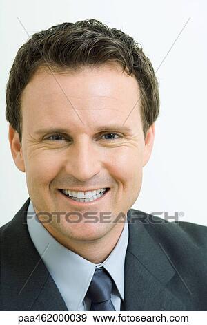 Stock Photo - Businessman smiling at camera, portrait. Fotosearch