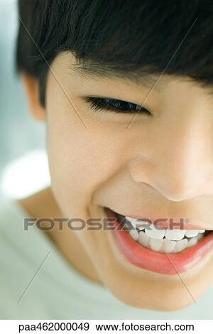Stock Photo - Cropped view of boy laughing, portrait. Fotosearch