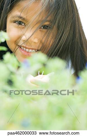 Girl smiling at camera, hair in face, portrait View Large Photo Image Stock Image - Girl smiling at camera, hair in face, portrait. Fotosearch