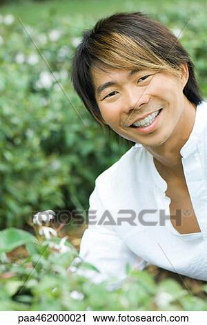 Stock Image - Man smiling at camera, portrait. Fotosearch