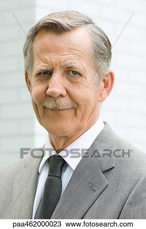 Stock Image - Senior man smiling at camera, portrait. Fotosearch
