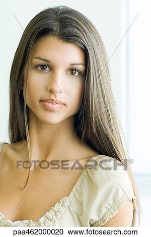 Stock Image - Teenage girl looking at camera, portrait. Fotosearch