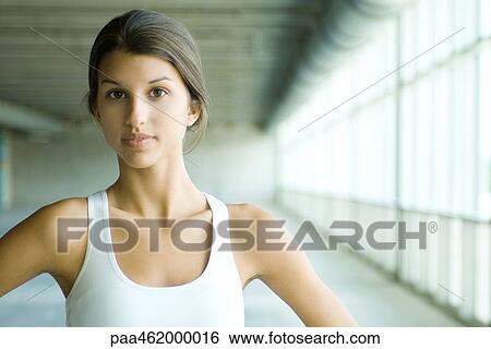 Teenage girl looking at camera, wearing tank top, portrait View Large Photo Image Stock Photograph - Teenage girl looking at camera, wearing tank top, portrait. Fotosearch