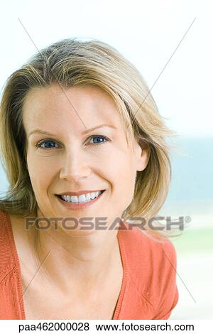 Stock Photo - Woman smiling at camera, portrait. Fotosearch
