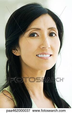 Stock Photo - Woman smiling at camera, portrait. Fotosearch