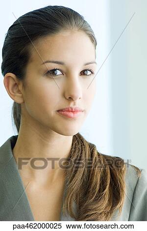 Young female in business attire looking at camera, portrait View Large Photo Image Stock Photography - Young female in business attire looking at camera, portrait. Fotosearch