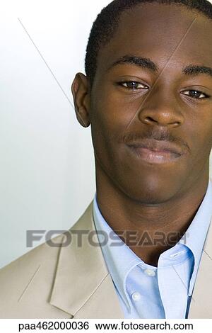 Young male in business attire smiling at camera, portrait View Large Photo Image Stock Photograph - Young male in business attire smiling at camera, portrait. Fotosearch