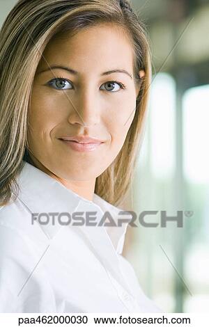 Young woman smiling at camera, portrait View Large Photo Image Stock Image - Young woman smiling at camera, portrait. Fotosearch