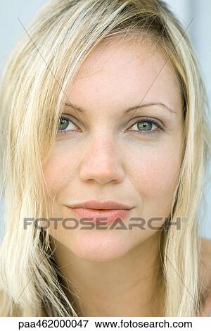 Stock Photo - Young woman smiling at camera, portrait. Fotosearch