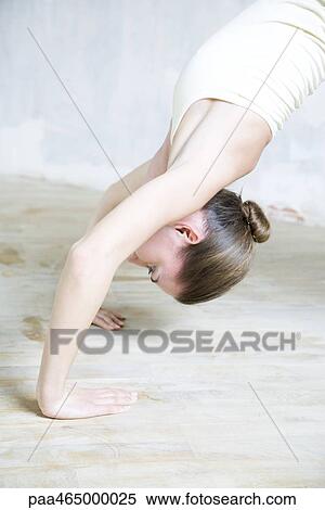 Stock Photography - Cropped view of woman doing backbend, waist up. Fotosearch