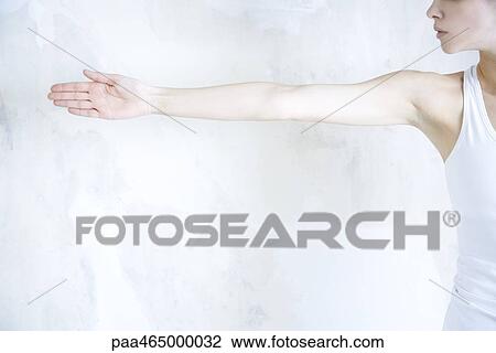 Cropped view of woman standing, arm outstretched View Large Photo Image Stock Image - Cropped view of woman standing, arm outstretched. Fotosearch