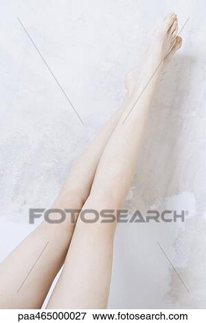 Cropped view of woman's bare legs, crossed at ankle View Large Photo Image Stock Photo - Cropped view of woman's bare legs, crossed at ankle. Fotosearch