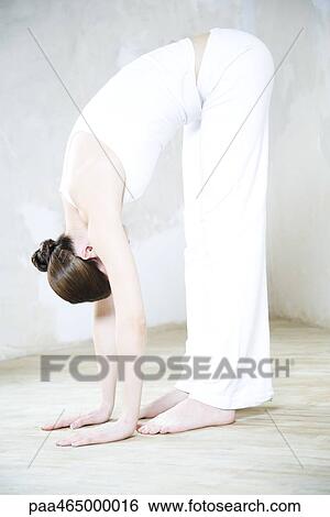 Woman bending over, touching toes, full length View Large Photo Image Stock Photograph - Woman bending over, touching toes, full length. Fotosearch