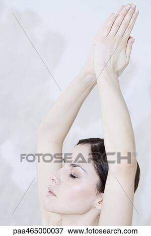 Woman doing prayer position, eyes closed, cropped view View Large Photo Image Stock Photo - Woman doing prayer position, eyes closed, cropped view. Fotosearch