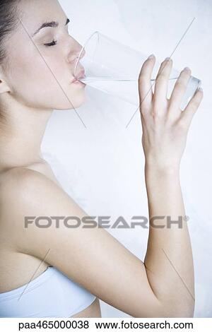 Woman drinking water, eyes closed, side view View Large Photo Image Stock Photo - Woman drinking water, eyes closed, side view. Fotosearch