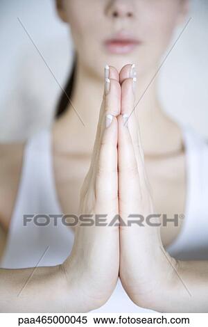 Stock Photography - Woman in prayer position, cropped view of hands. Fotosearch
