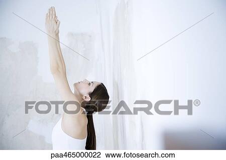 Woman stretching, arms raised, looking up, head and shoulders View Large Photo Image Stock Image - Woman stretching, arms raised, looking up, head and shoulders. Fotosearch