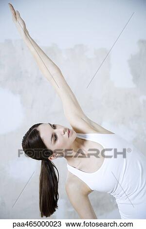 Woman stretching, one arm raised, looking up View Large Photo Image Stock Image - Woman stretching, one arm raised, looking up. Fotosearch