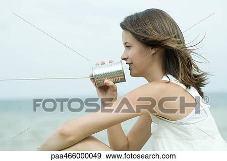 Teen girl talking into tin can phone, profile View Large Photo Image Stock Photo - Teen girl talking into tin can phone, profile. Fotosearch