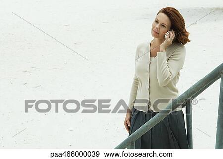 Woman using cell phone, looking away View Large Photo Image Stock Photo - Woman using cell phone, looking away. Fotosearch