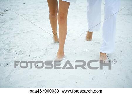 Couple walking on sand, cropped view of legs View Large Photo Image Stock Image - Couple walking on sand, cropped view of legs. Fotosearch