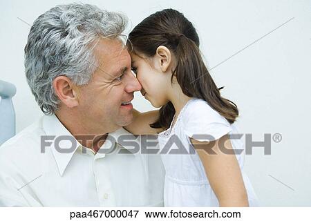 Little girl whispering to mature man, side view View Large Photo Image Stock Photo - Little girl whispering to mature man, side view. Fotosearch