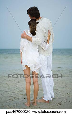 Man and teenage girl on beach, standing together, looking at view, full length, rear view View Large Photo Image Stock Image - Man and teenage girl on beach, standing together, looking at view, full length, rear view. Fotosearch
