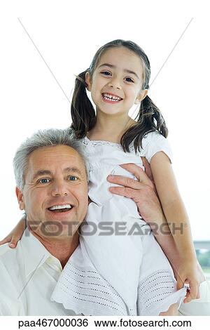 Man holding up little girl, both smiling at camera, portrait View Large Photo Image Stock Photograph - Man holding up little girl, both smiling at camera, portrait. Fotosearch