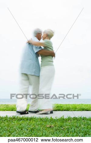 Senior couple dancing on sidewalk overlooking ocean, full length, blurred motion View Large Photo Image Stock Image - Senior couple dancing on sidewalk overlooking ocean, full length, blurred motion. Fotosearch
