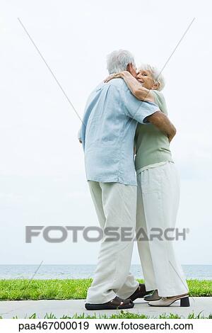 Senior couple dancing on sidewalk overlooking ocean, full length View Large Photo Image Stock Photo - Senior couple dancing on sidewalk overlooking ocean, full length. Fotosearch