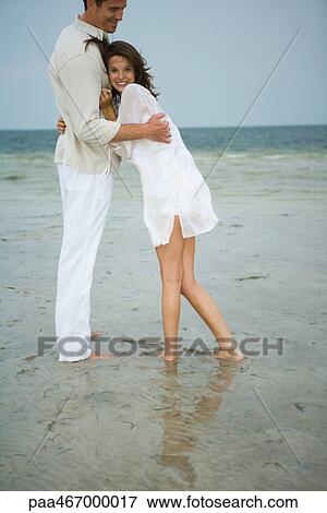 Stock Photo - Teen girl leaning against man's chest, smiling at camera. Fotosearch