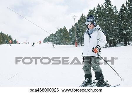 Stock Photograph - Boy skiing, full length. Fotosearch