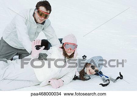 Group of young friends playfighting in snow, teen girl waving to camera View Large Photo Image Picture - Group of young friends playfighting in snow, teen girl waving to camera. Fotosearch