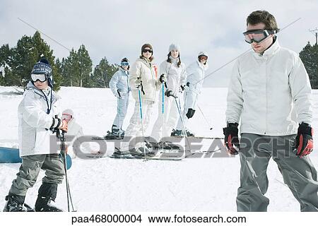 Picture - Group of young skiers standing on snow. Fotosearch