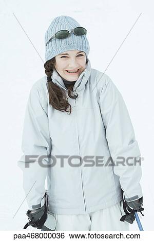 Stock Photograph - Teen girl skier smiling at camera, portrait. Fotosearch